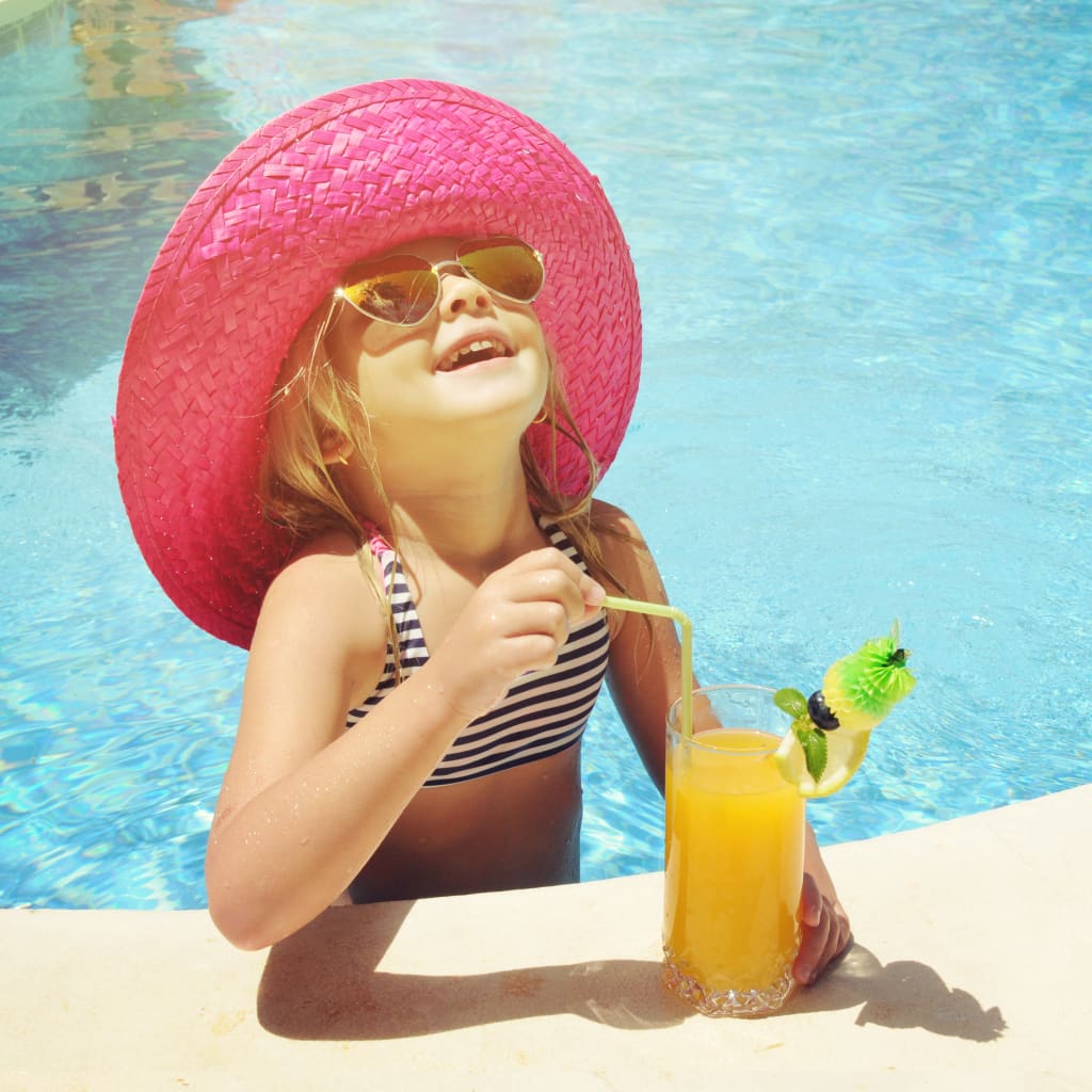 Child swimming enjoying citrus juice