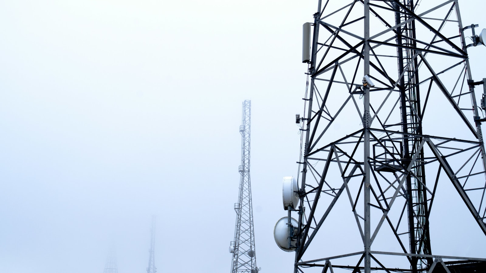 Telecommunications masts and antenna arrays against an open sky
