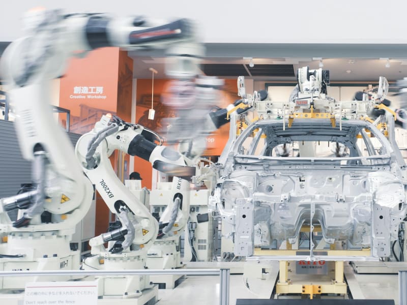 Robotic arms assembling a car chassis on an automotive production line