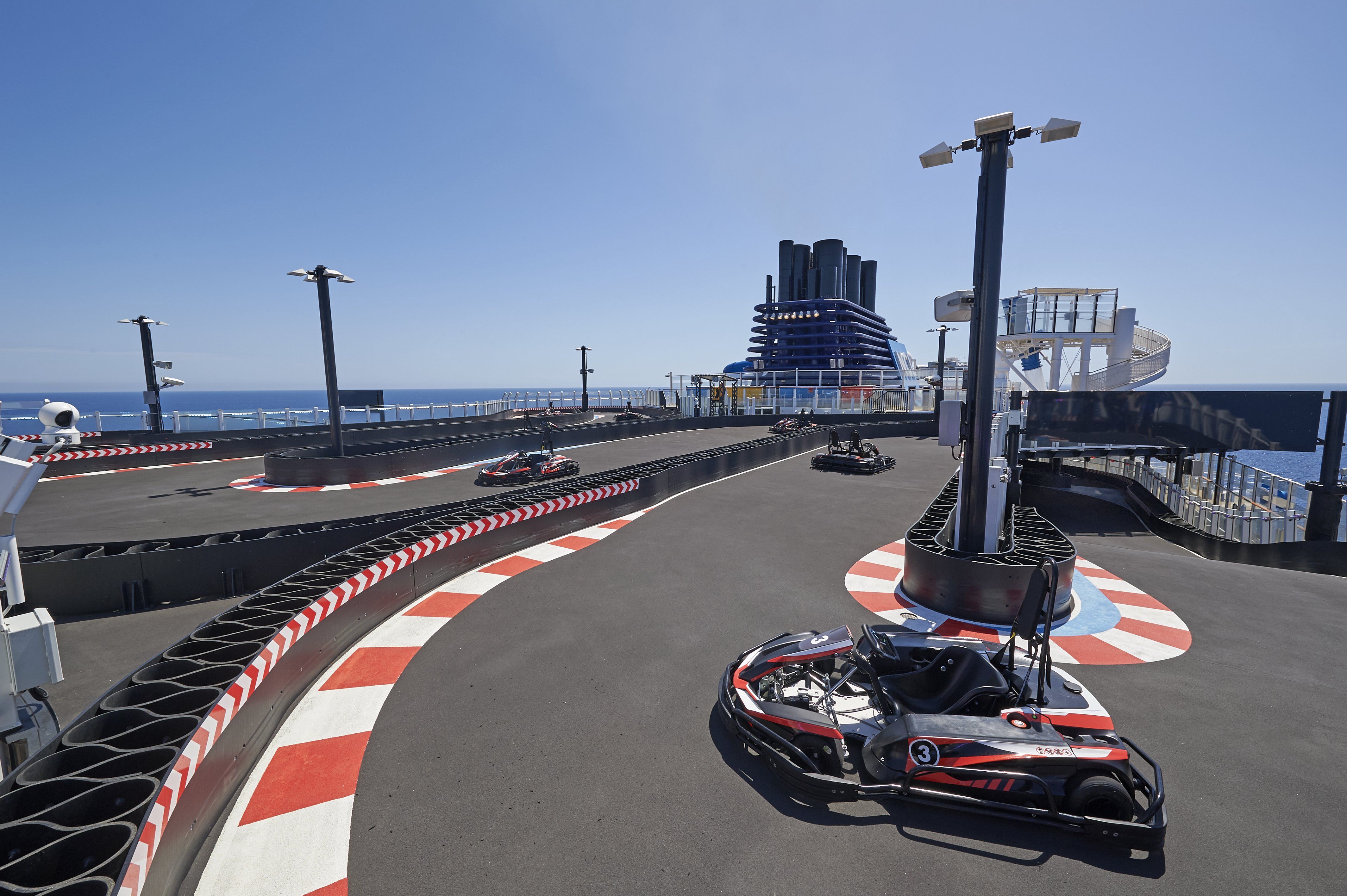 Race Track at sea on Norwegian Cruise Line ship, go-karts racing on a clear day with ocean backdrop.