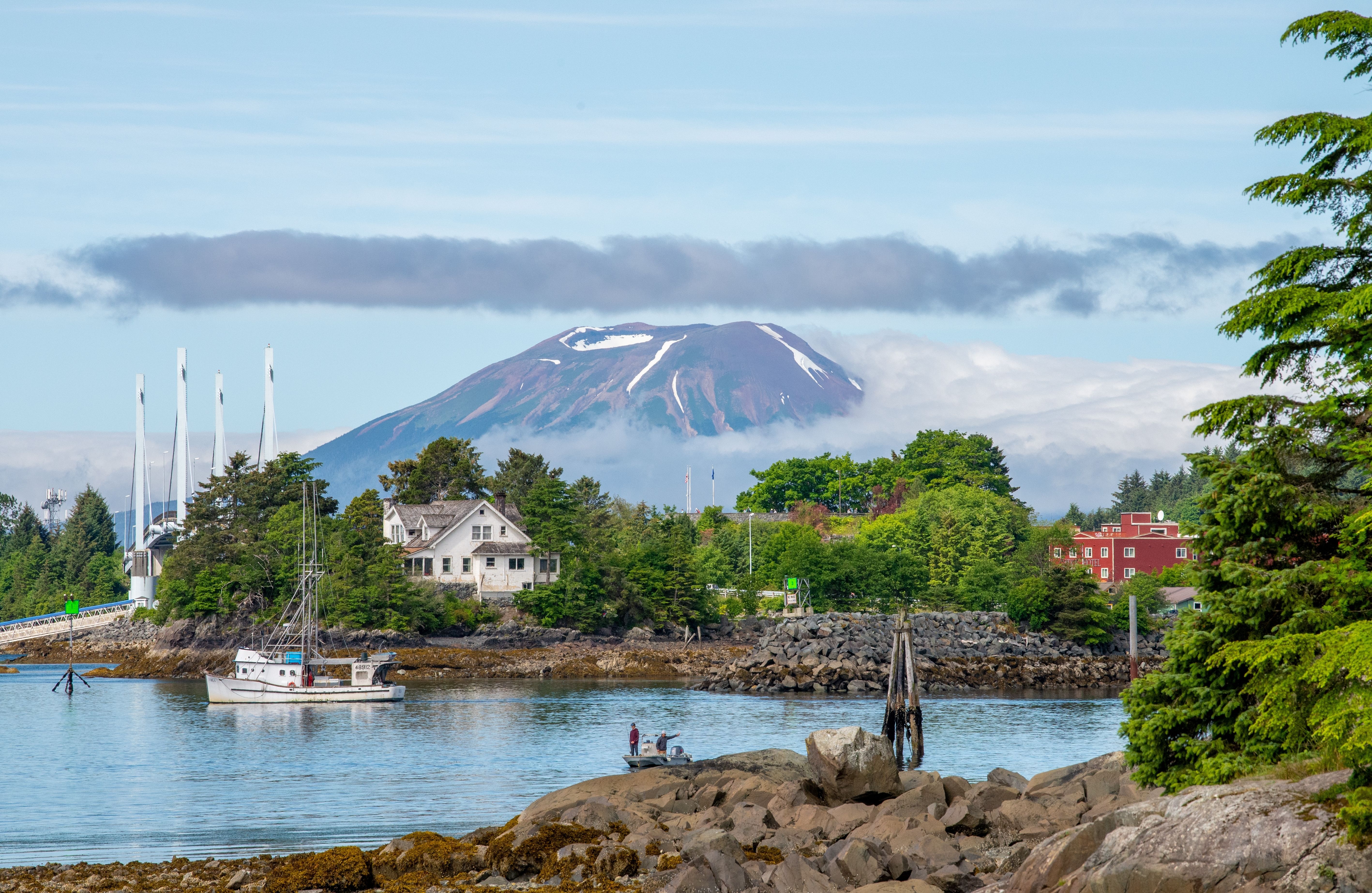 View of a volcano and harbor in Sitka, Alaska, from a cruise ship, highlighting a typical Alaskan cruise port.