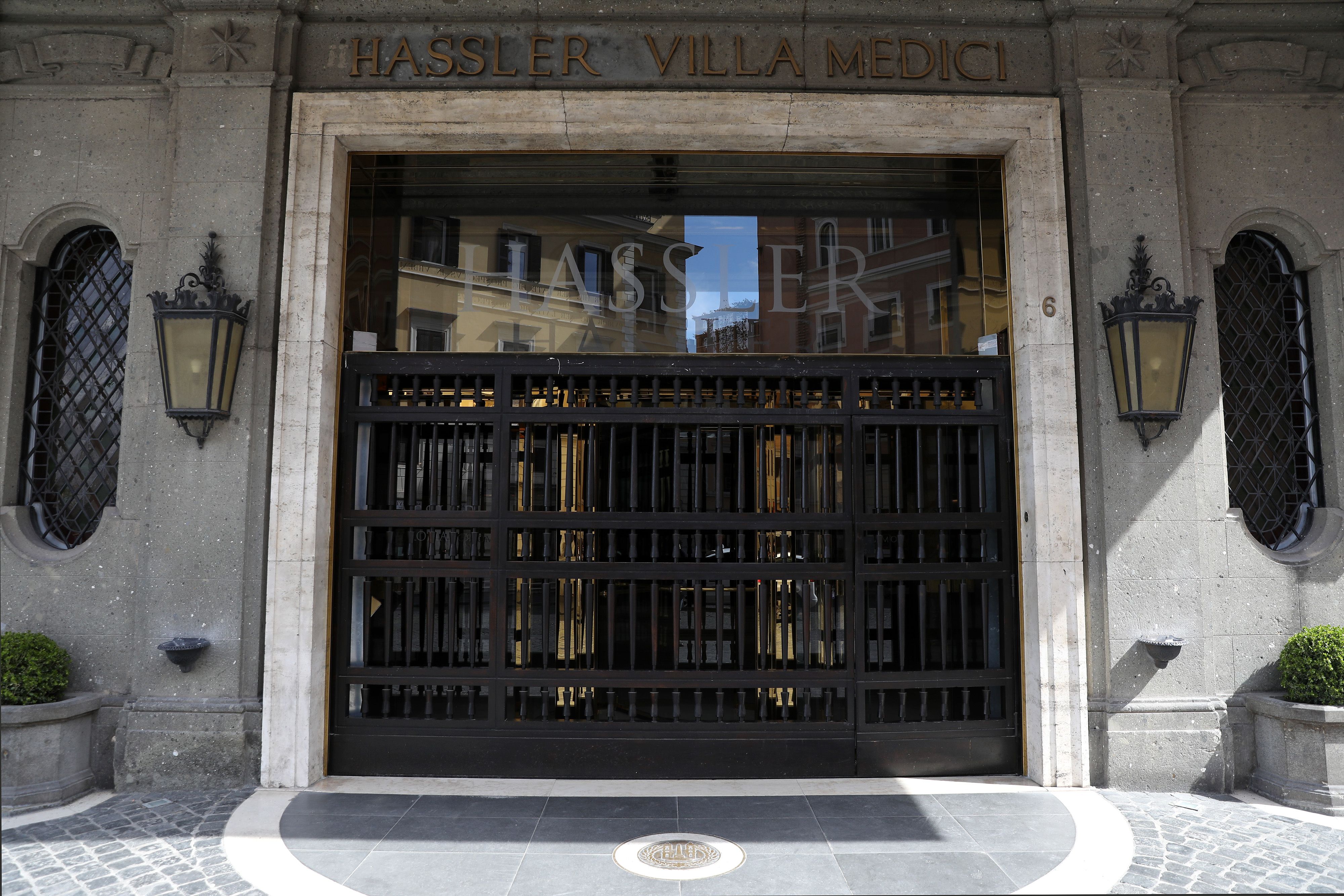 Entrance to Hassler Hotel Villa Medici, Rome, with its grand facade and iron gate.