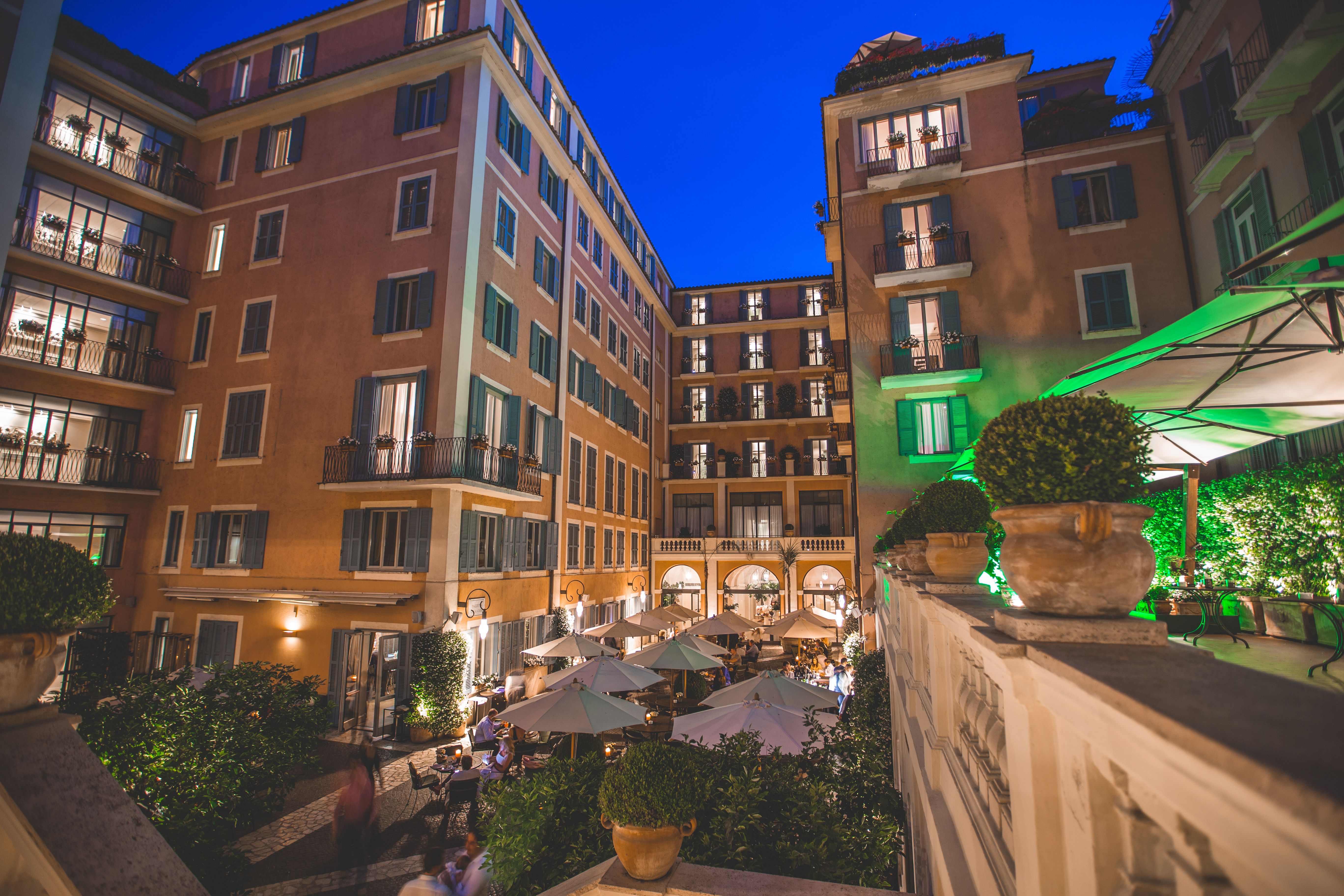 Evening at Hotel de Russie, Rome, with its elegant courtyard dining area and warmly lit surroundings.