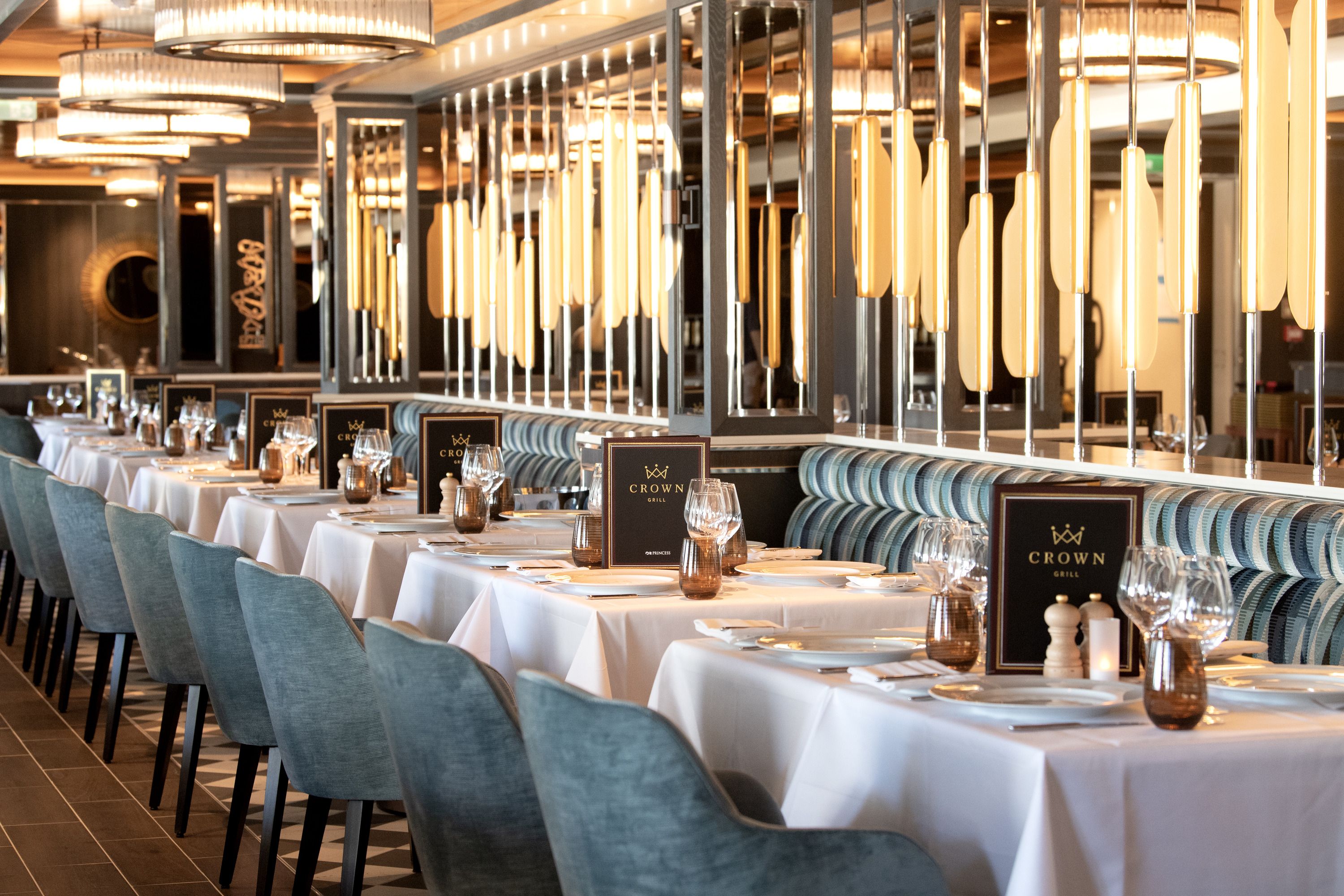 Crown Grill on Sun Princess, featuring stylish decor, cozy booth seating, and sophisticated table settings for an upscale steakhouse dining experience.