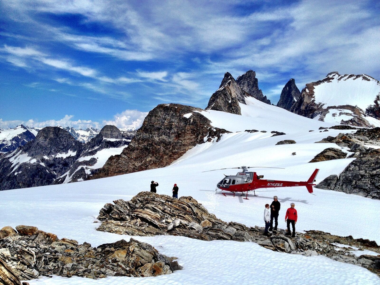 Scenic aerial view from a helicopter tour over Juneau, Alaska, showcasing glaciers, rugged mountains, and breathtaking wilderness.