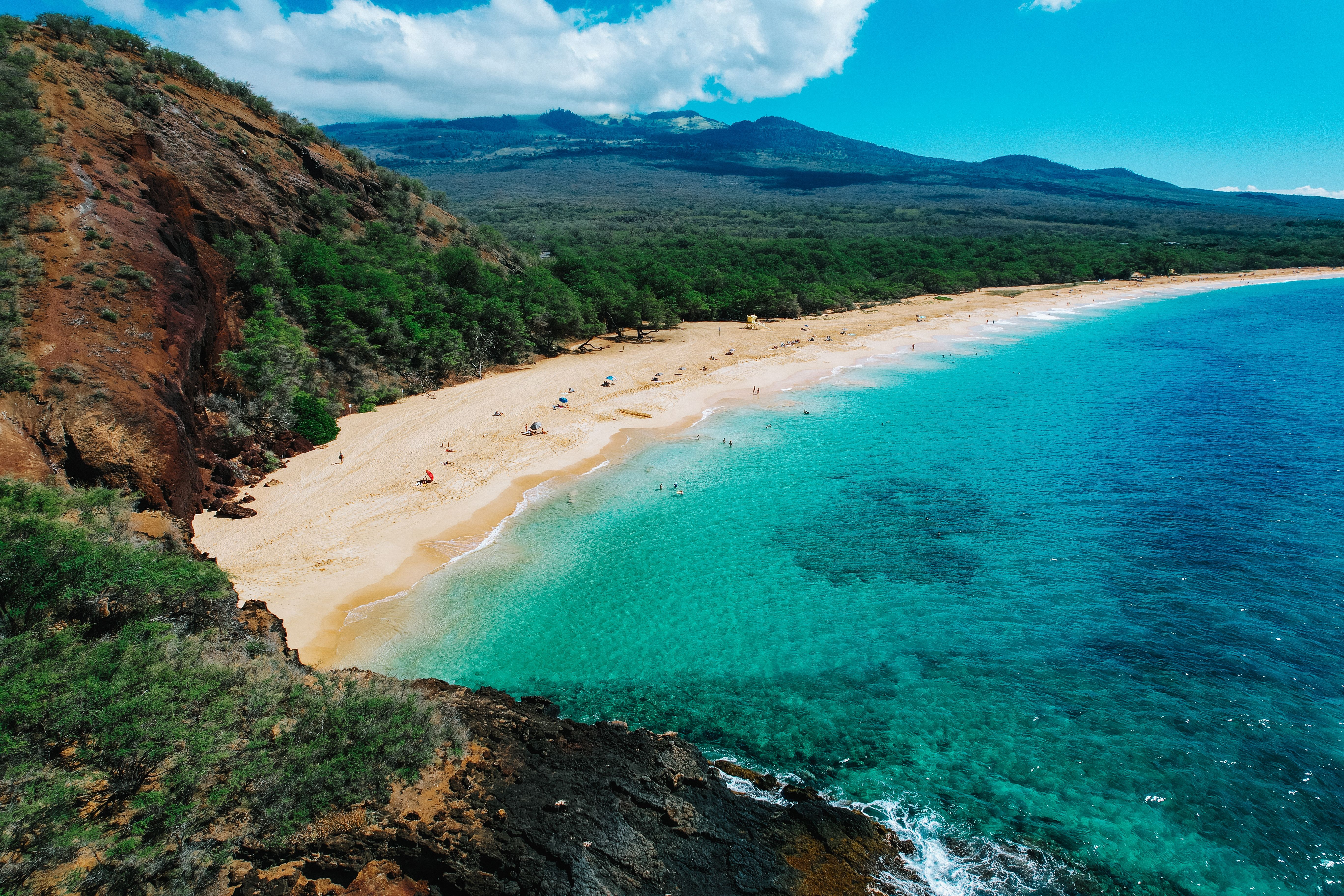 Aerial view of Big Beach in Maui, Hawaii, with golden sand, turquoise waters, and volcanic cliffs.