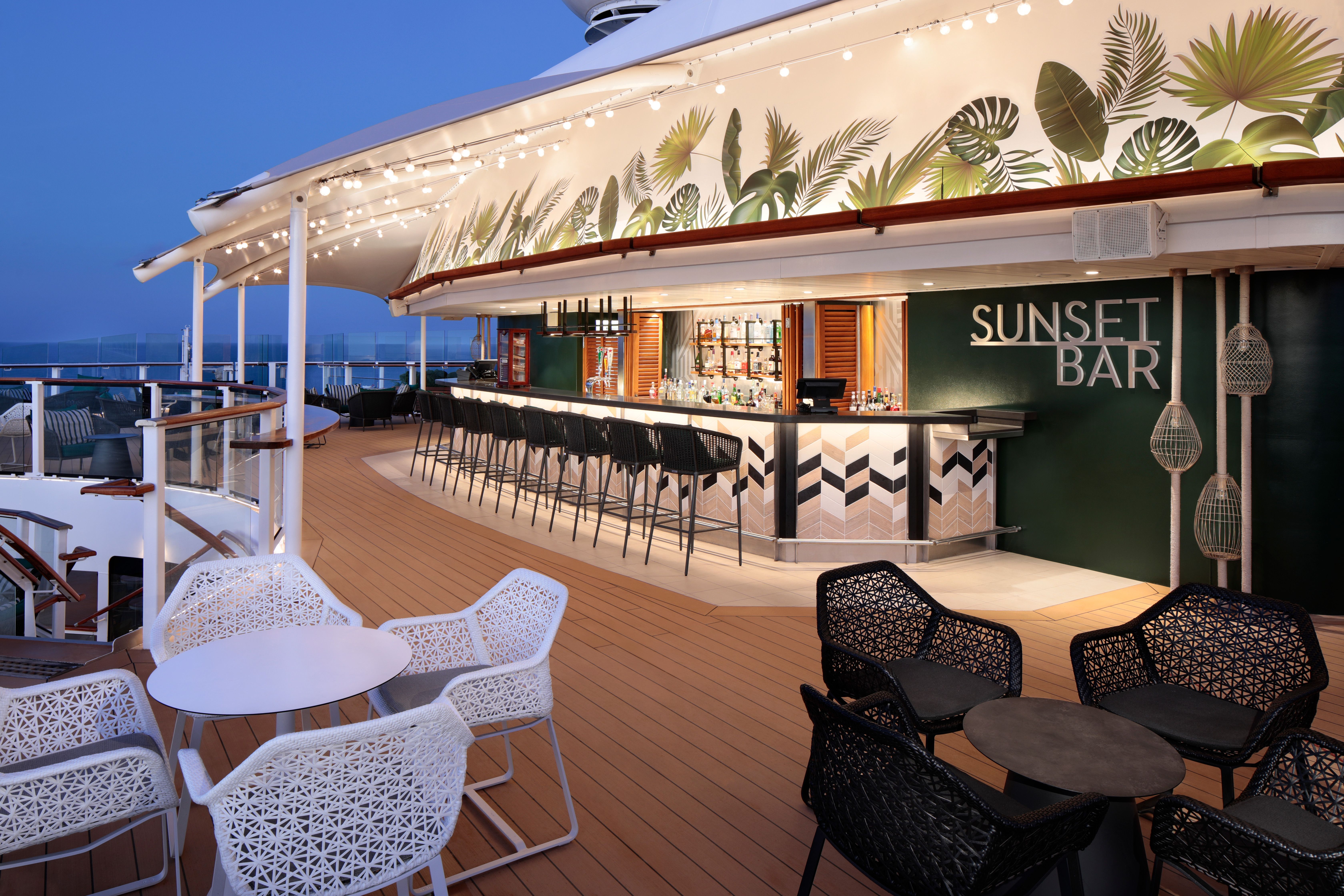 Sunset Bar on a Celebrity cruise ship with tropical decor, stylish seating, and ocean views, perfect for sunset cocktails.