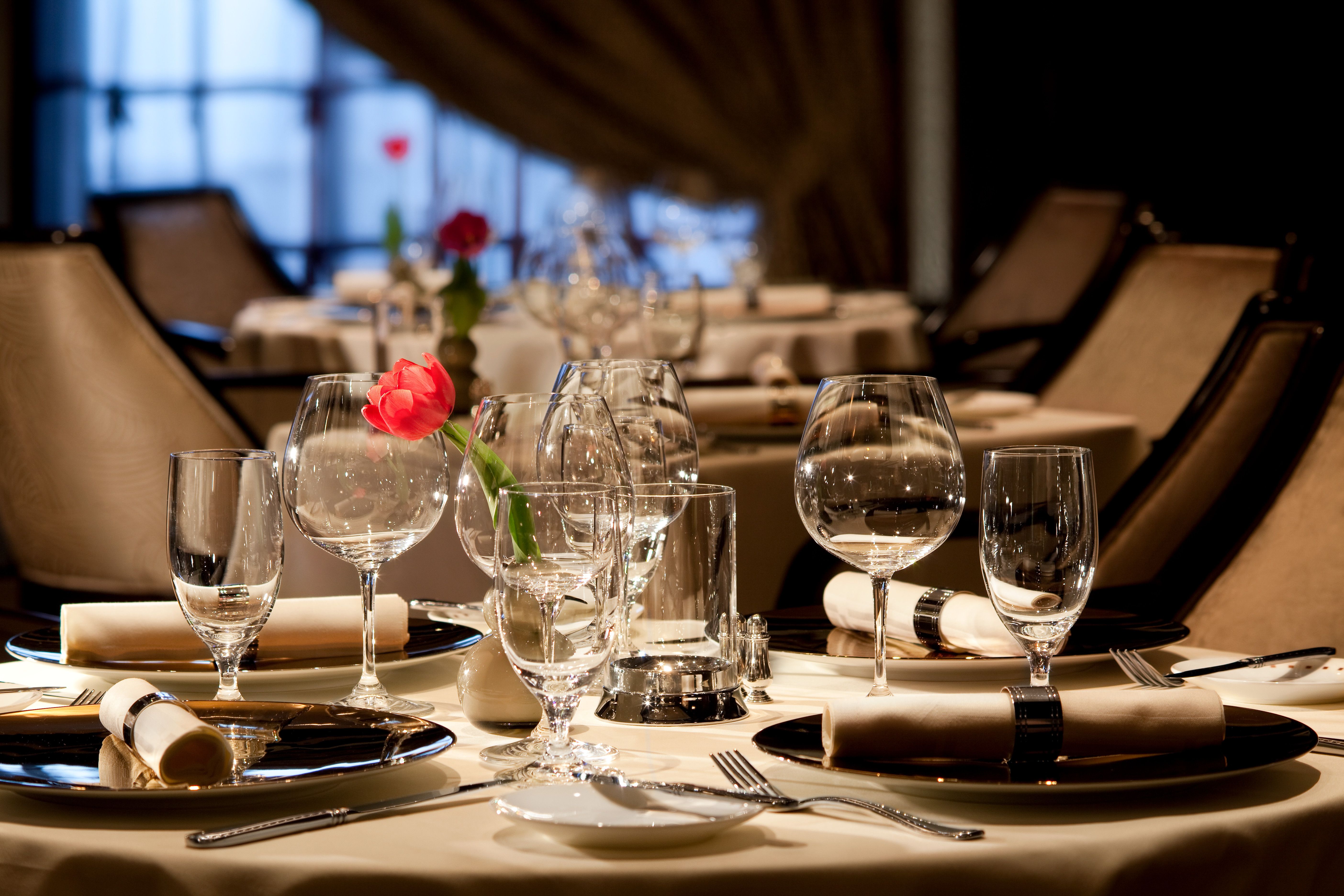 Murano restaurant on a Celebrity cruise ship with elegant table settings, fine glassware, and a romantic ambiance for gourmet dining.