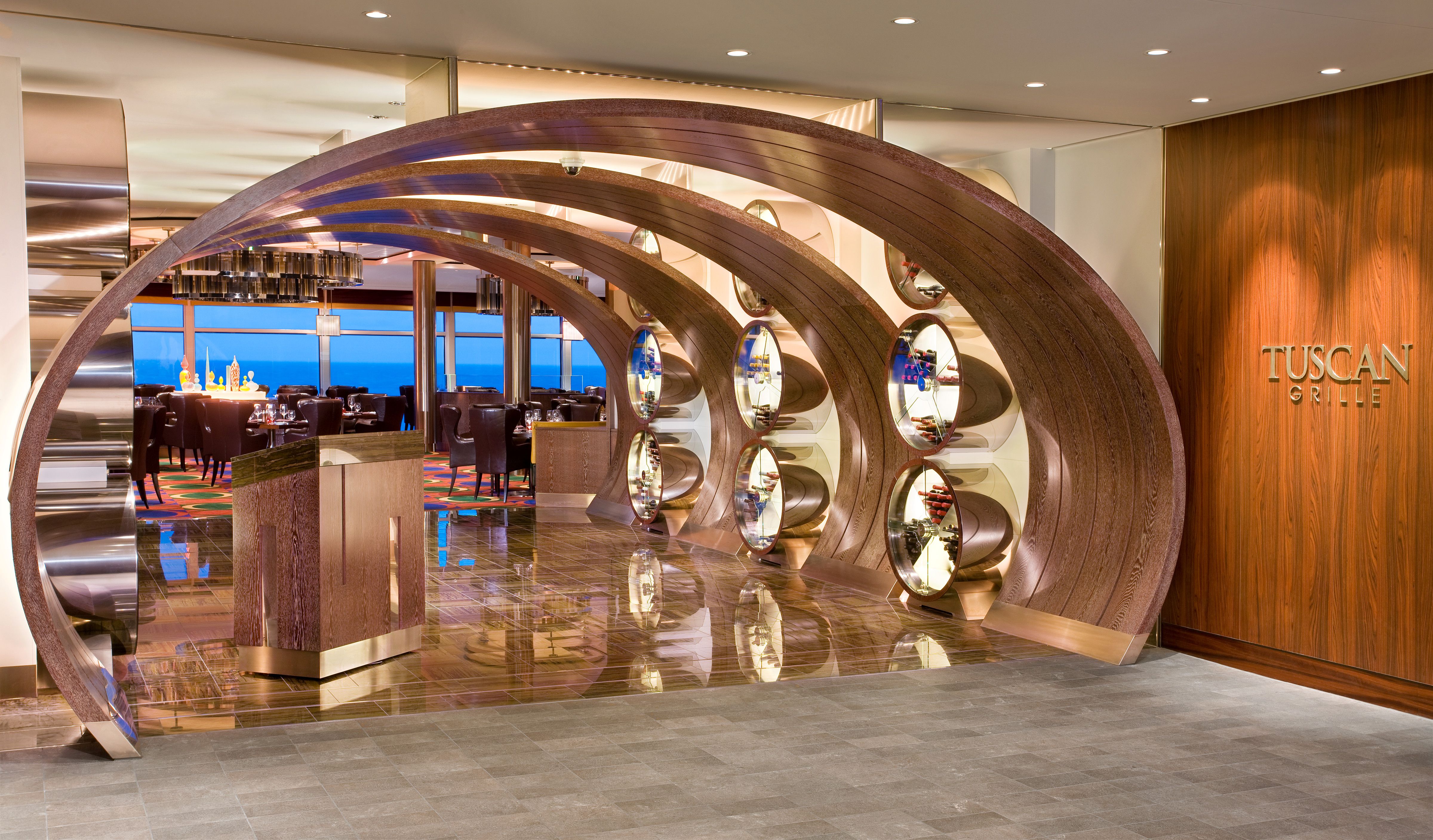 Tuscan Grille on a Celebrity cruise ship with stylish wood arches, wine displays, and ocean views, offering Italian-inspired cuisine.