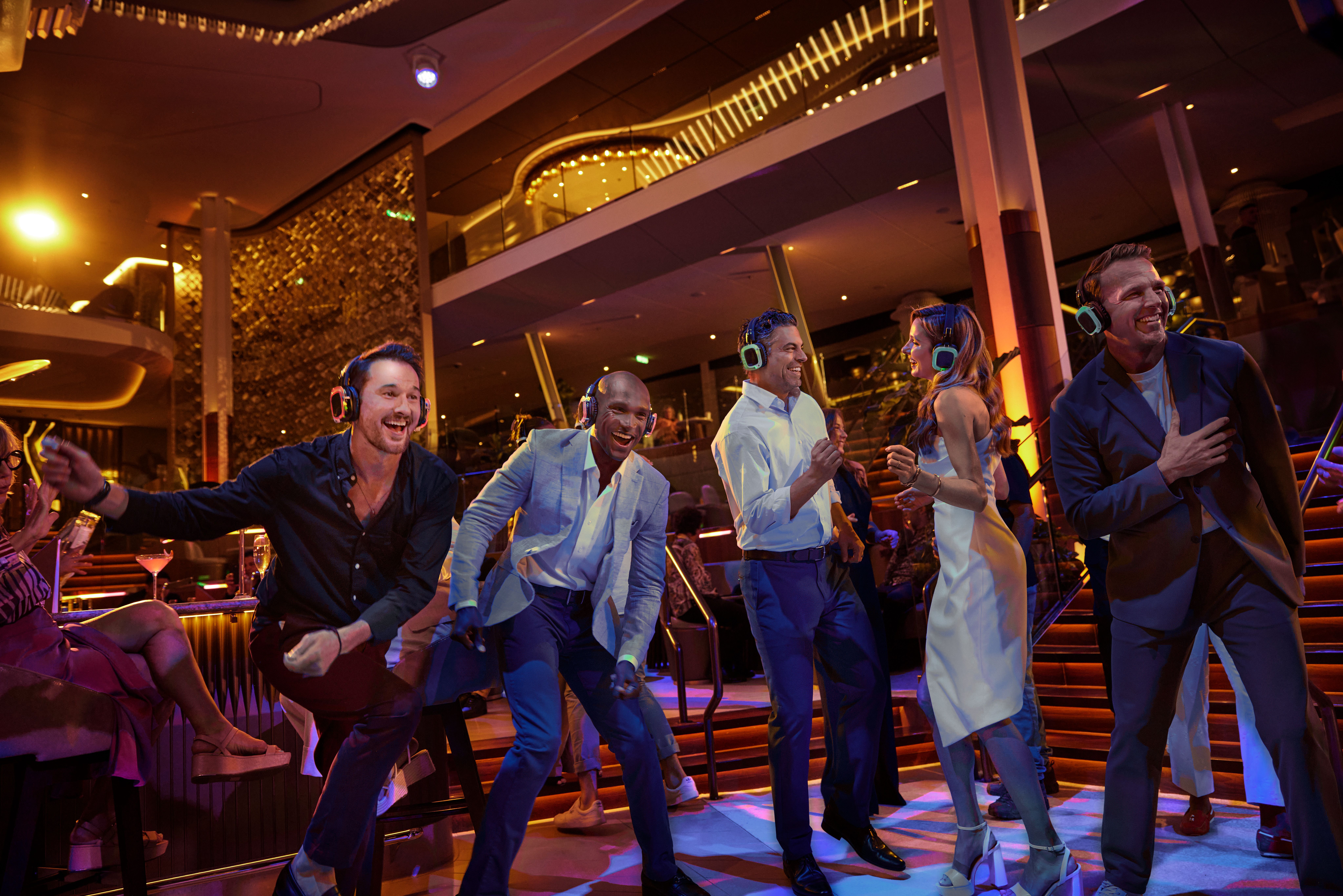 Silent Disco on a Celebrity cruise ship with guests wearing headphones, dancing, and enjoying a vibrant nightlife atmosphere.