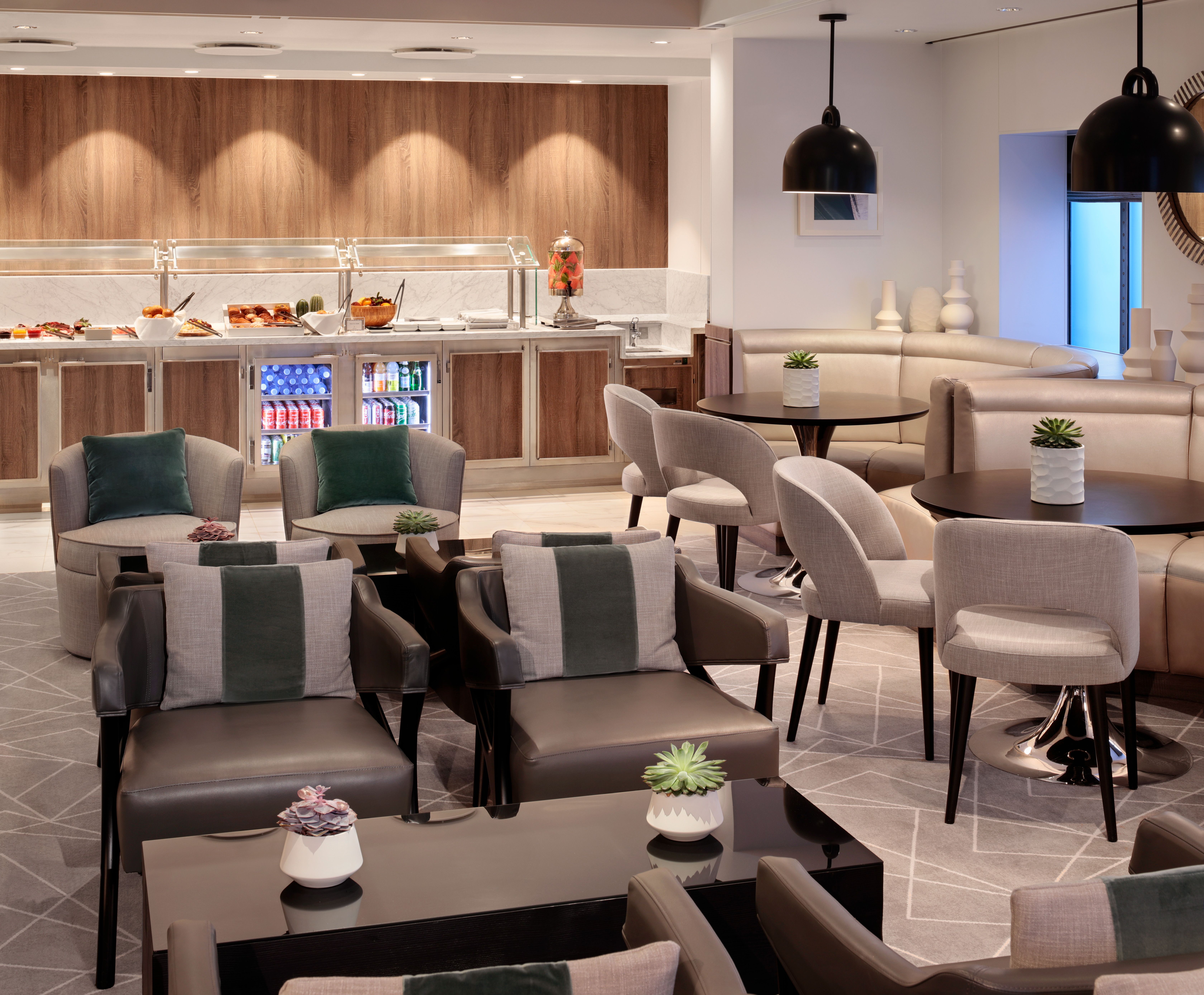 Retreat Lounge on a Celebrity cruise ship with elegant seating, a self-serve buffet, and a relaxing, exclusive atmosphere for suite guests.