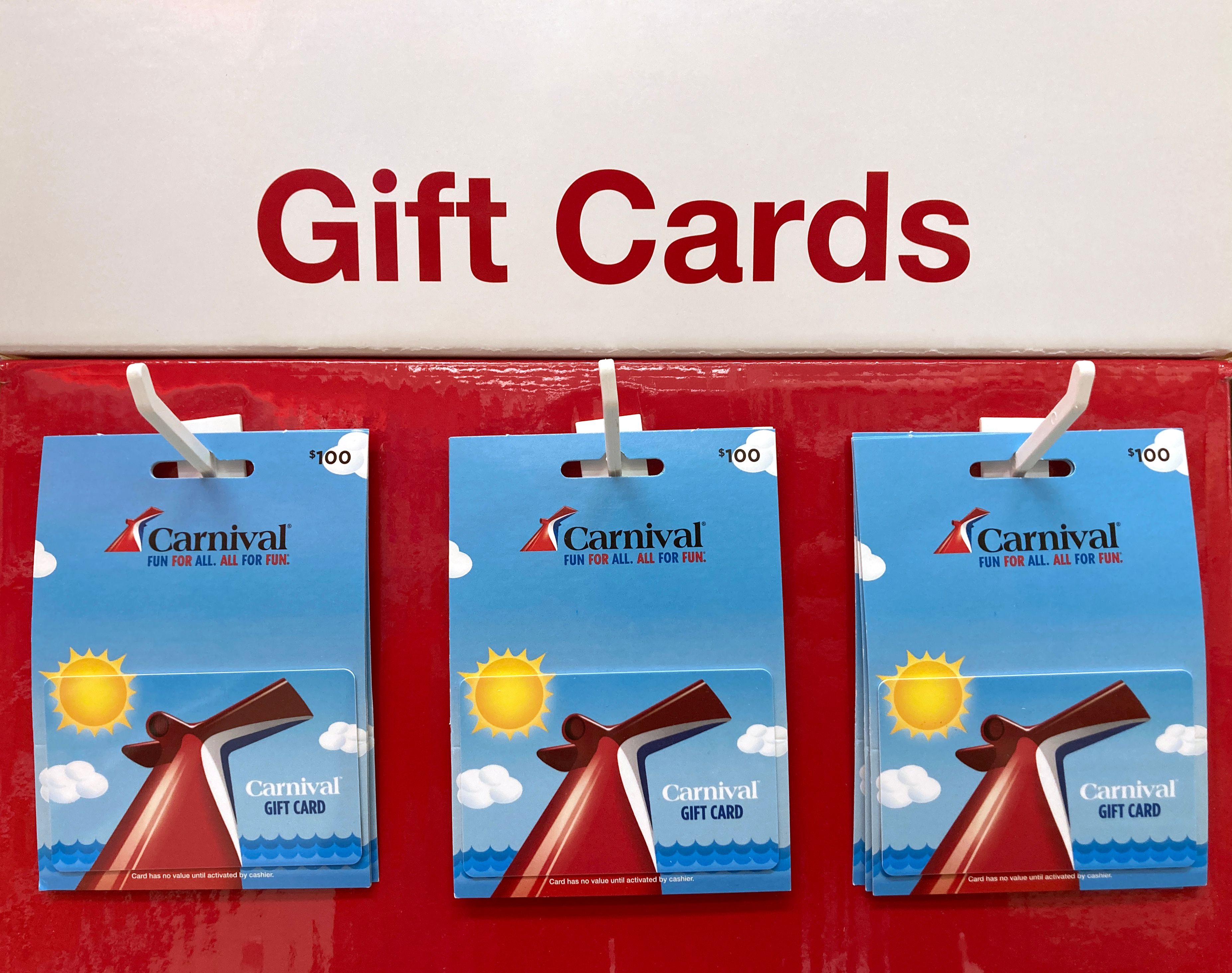 Carnival Cruise Line $100 gift cards on display, featuring the iconic red funnel against a sunny ocean backdrop, perfect for booking cruise vacations.