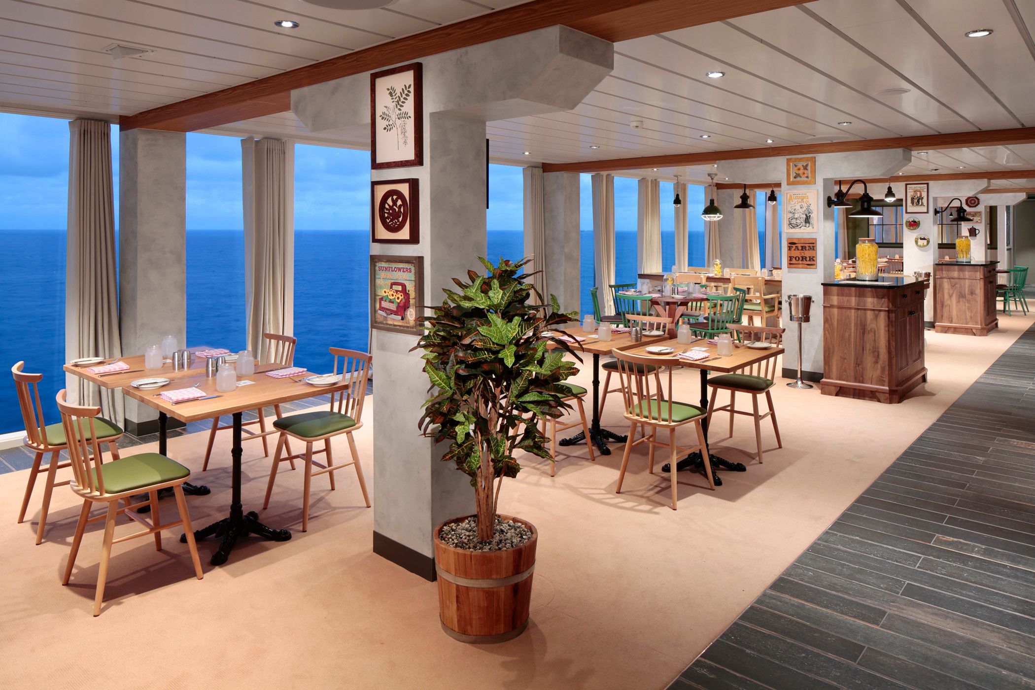 Mason Jar Southern-style restaurant on Wonder of the Seas with ocean views, rustic decor, and casual wooden seating.