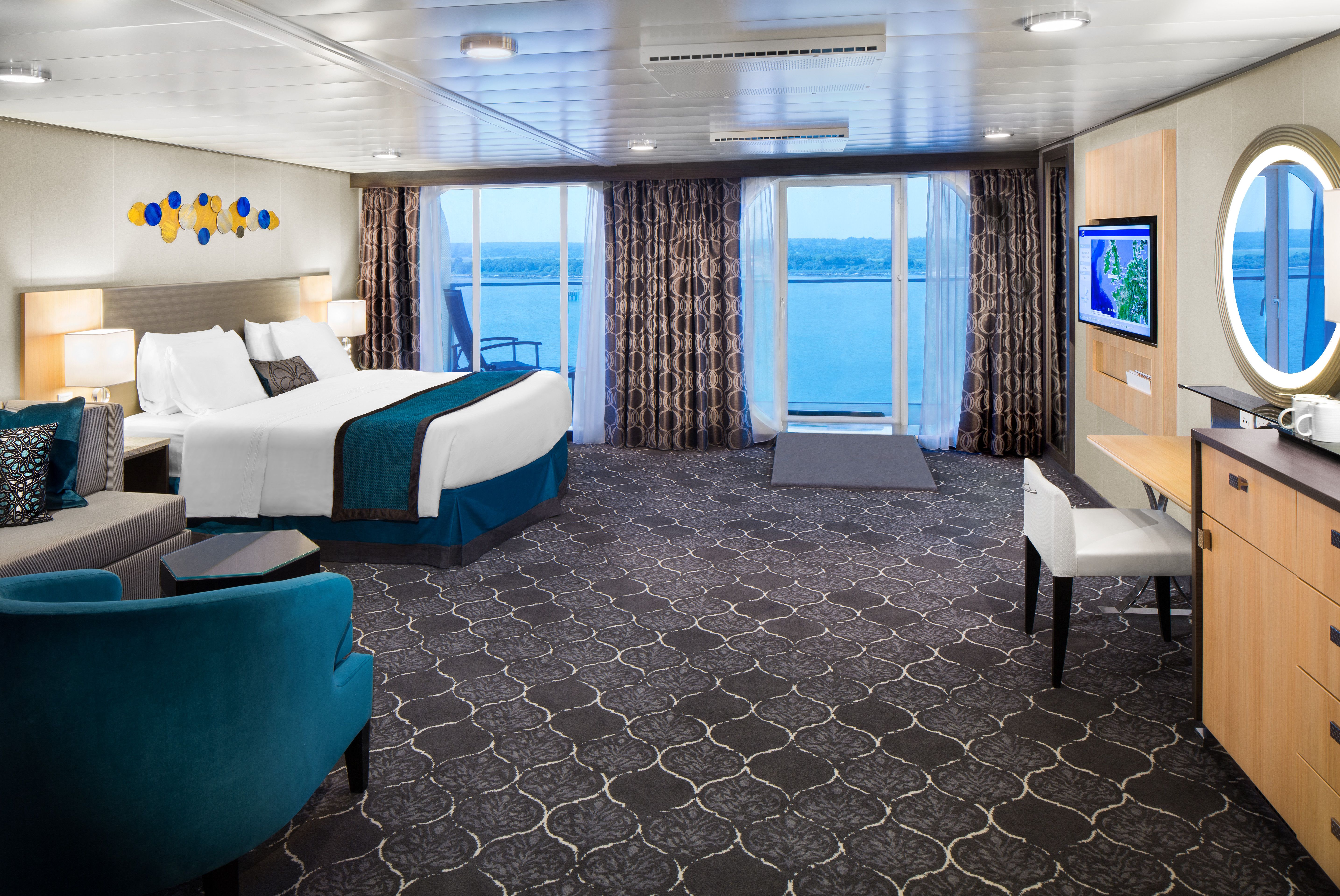 Spacious Junior Suite on Harmony of the Seas with king bed, oceanview balcony, and sitting area
