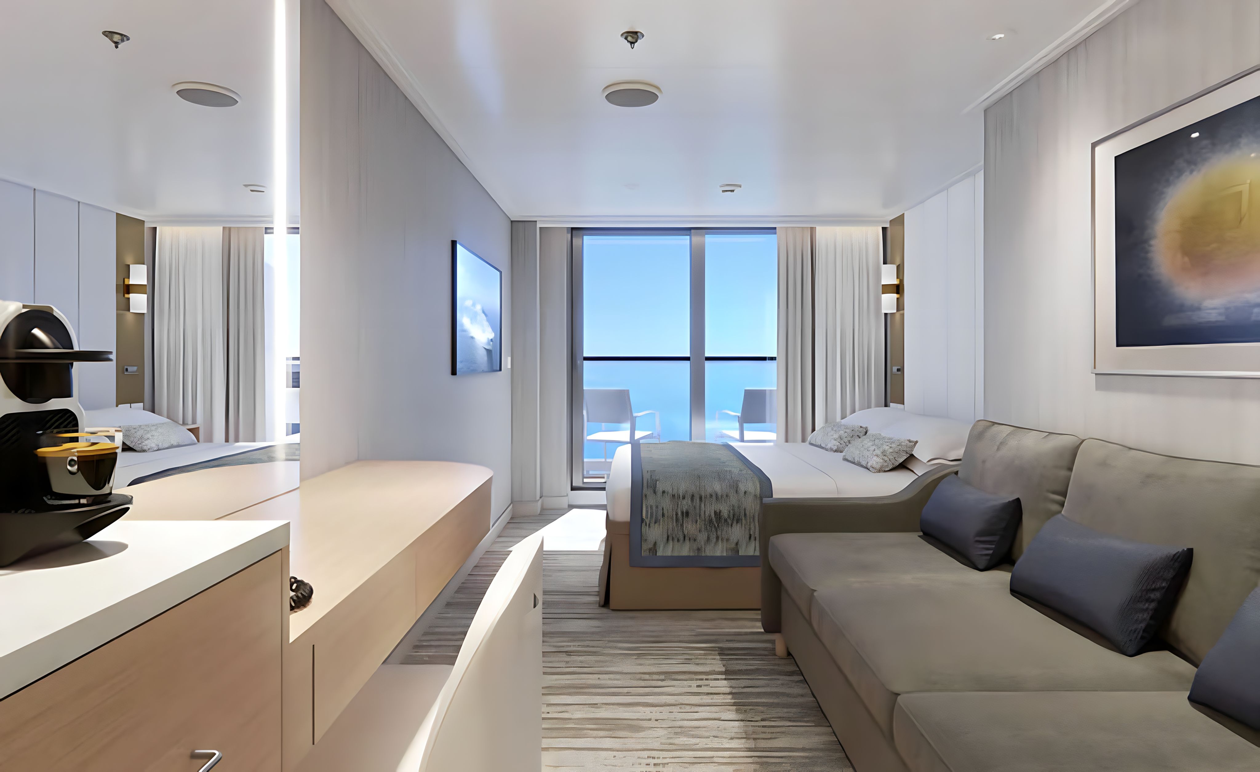 Premium Deluxe Balcony cabin featuring plush bedding, wall-mounted TV, desk vanity and floor-to-ceiling doors to a spacious veranda.