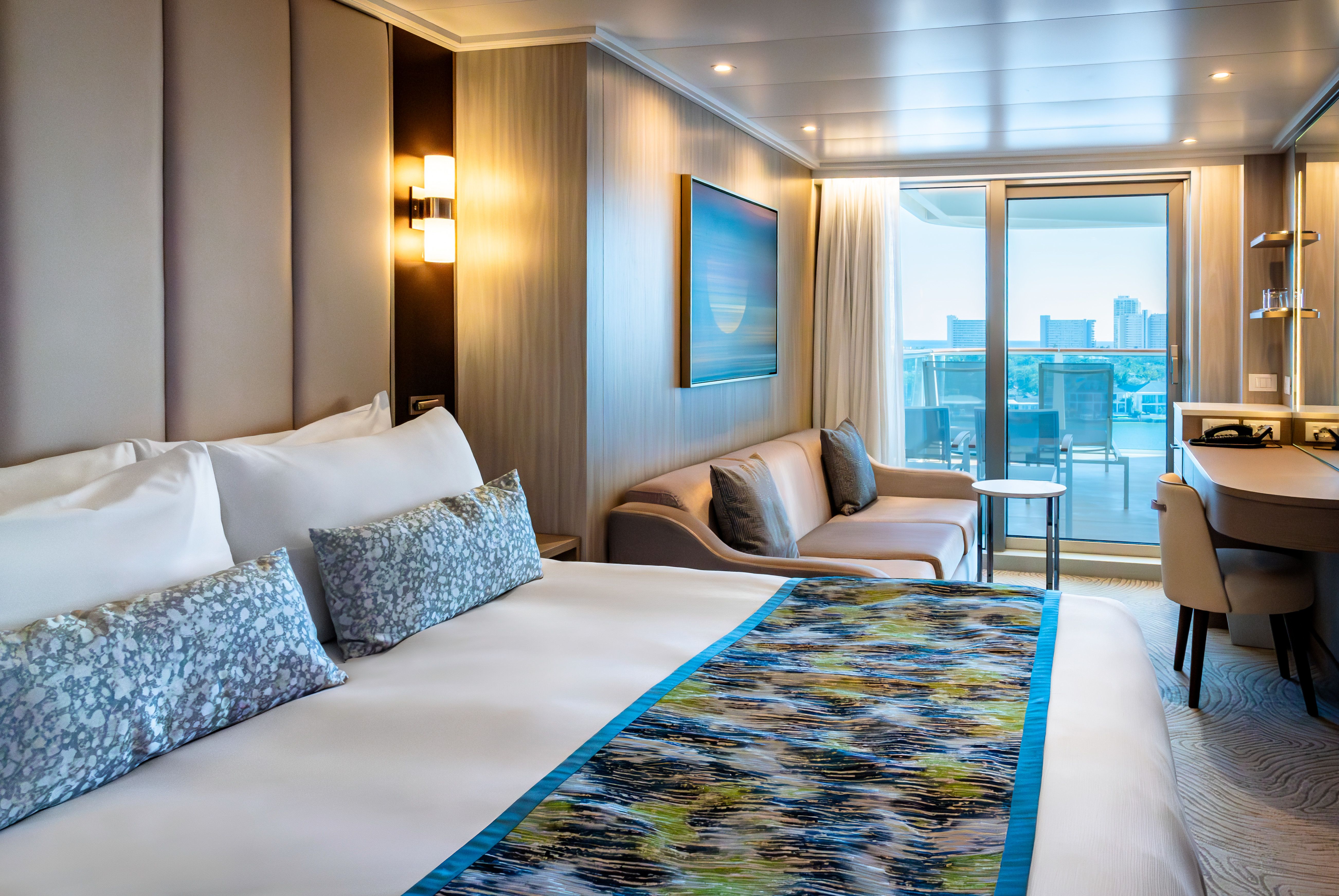 Premium Deluxe Balcony stateroom with king bed, sofa sitting area and private oceanview balcony on Princess Cruises.