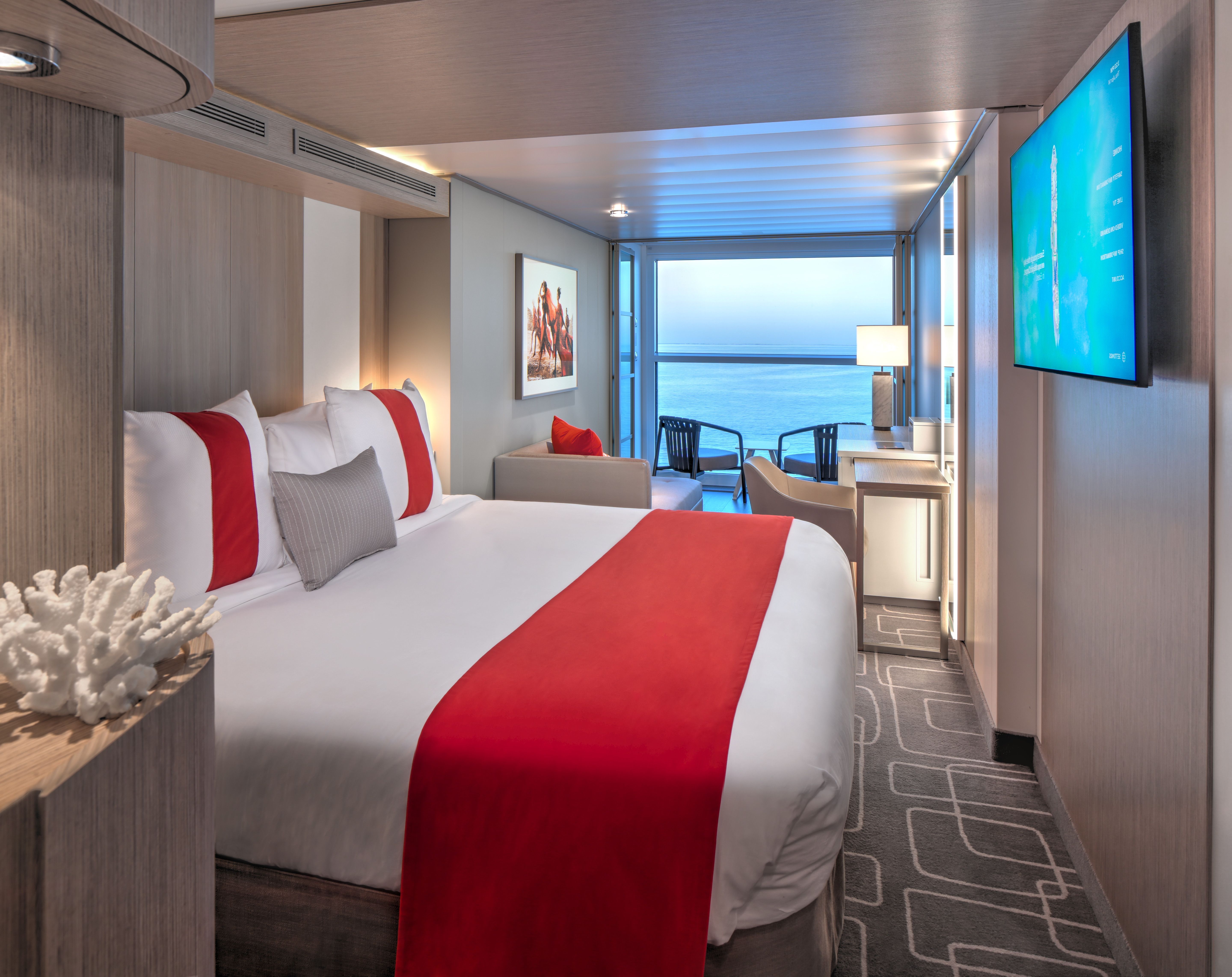 Edge Stateroom with Infinite Veranda on Celebrity Cruises featuring king-size bed, modern seating area and floor-to-ceiling ocean views