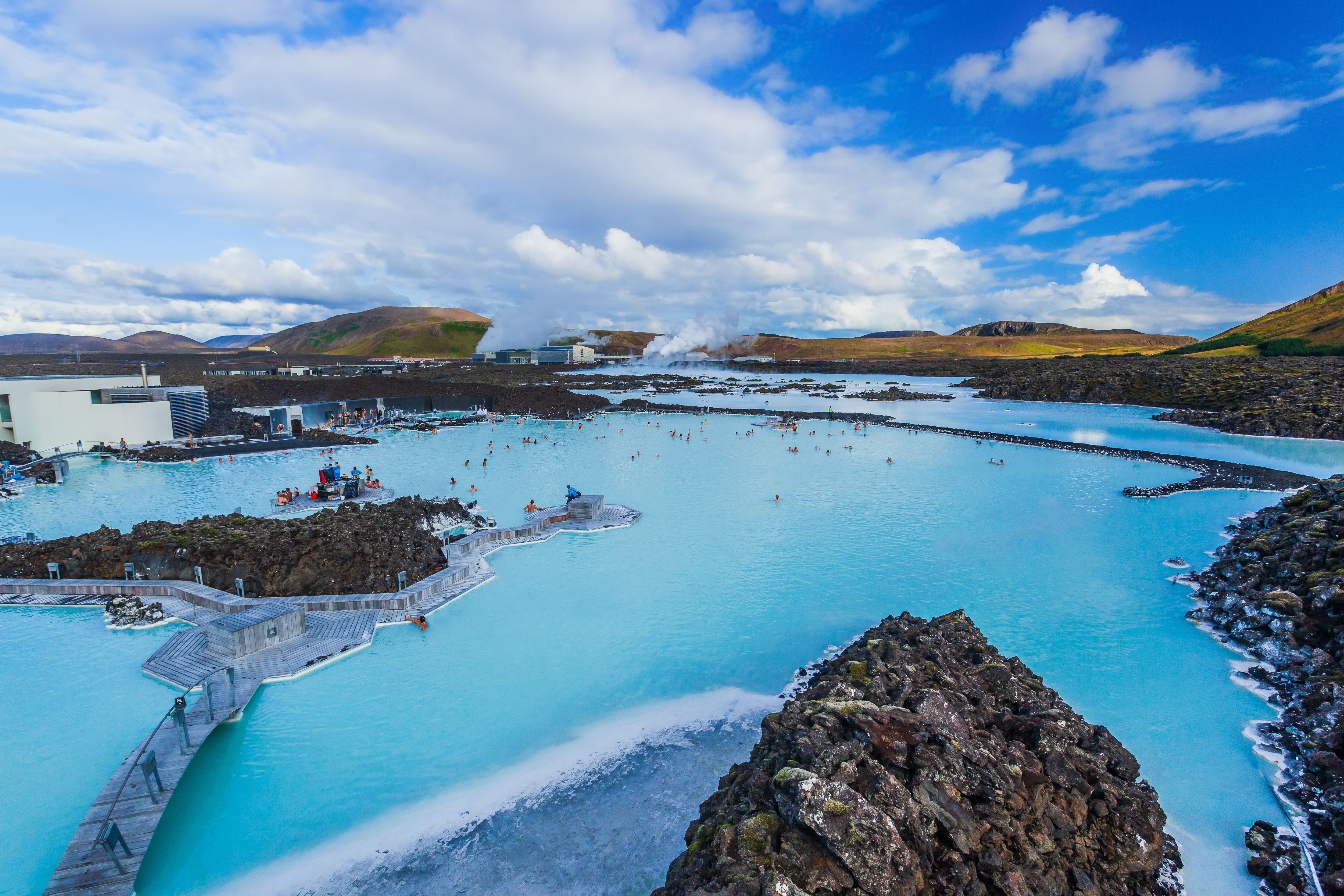 Blue Lagoon geothermal spa in Iceland, featuring milky-blue mineral-rich waters, volcanic lava fields, and visitors enjoying a popular Reykjavik shore excursion