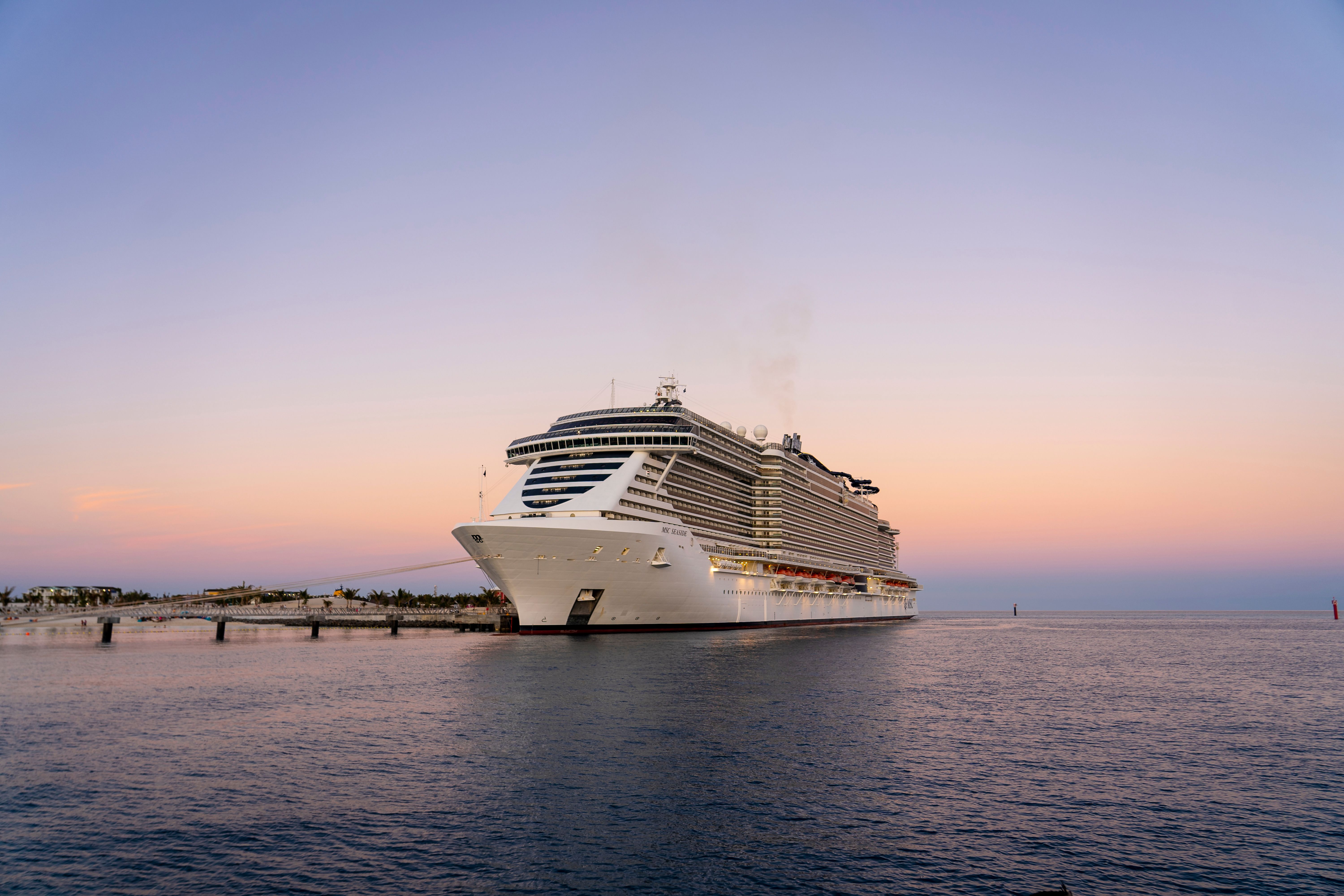 MSC Seaside docked at Ocean Cay MSC Marine Reserve at sunset, offering cruise guests an overnight stay at the private island destination.