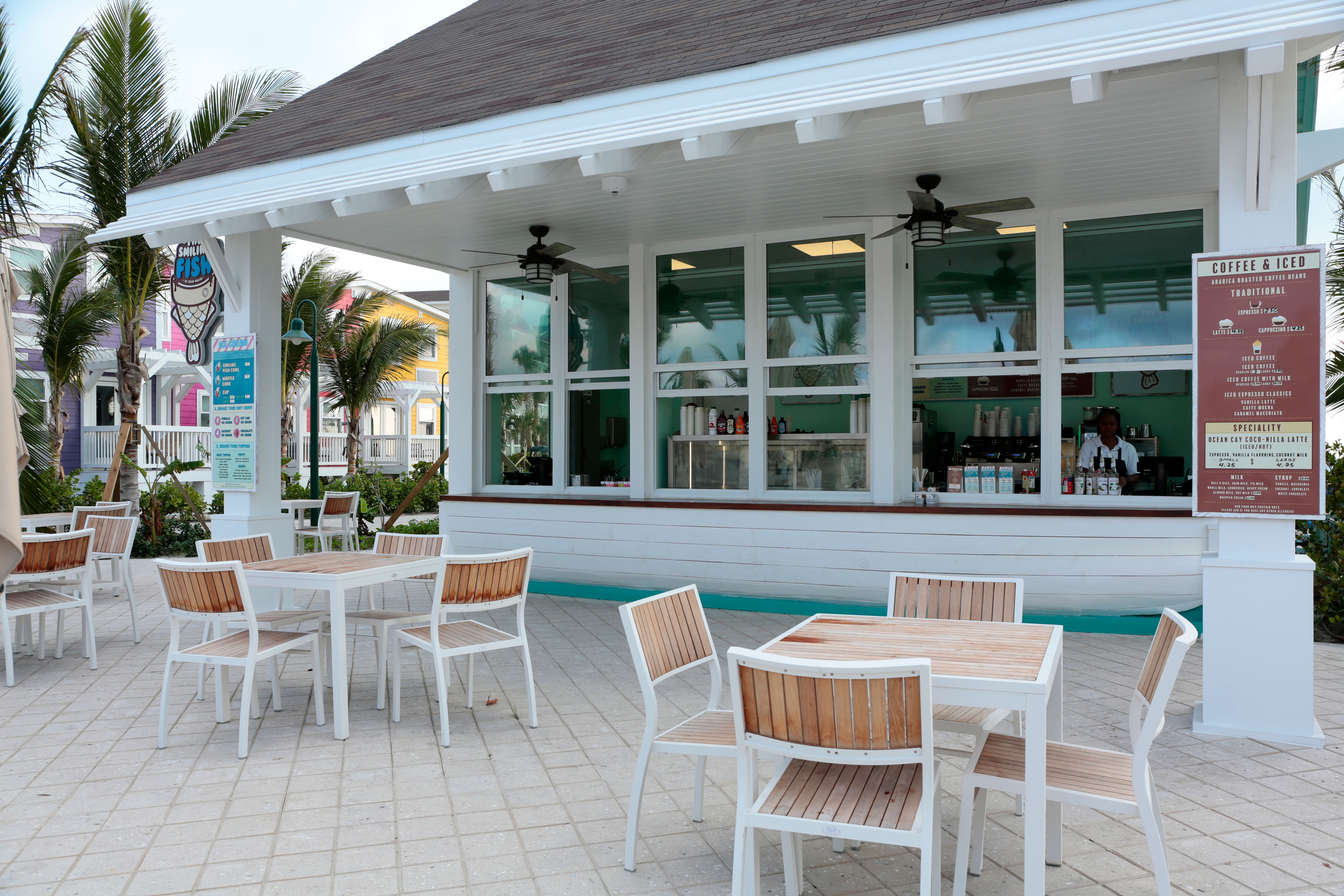 The Smiling Fish café with outdoor seating, tropical palms and a coffee bar at Ocean Cay MSC Marine Reserve.
