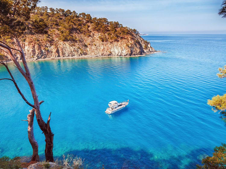 Antalya, T&uuml;rkei &ndash; Ein Boot liegt still im t&uuml;rkisblauen Wasser