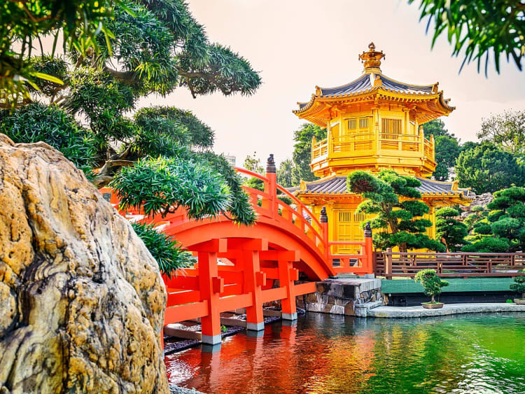 Hongkong, China &ndash; Rote Br&uuml;cke f&uuml;hrt zum goldenen Pavillon im stillen Gartenweiher