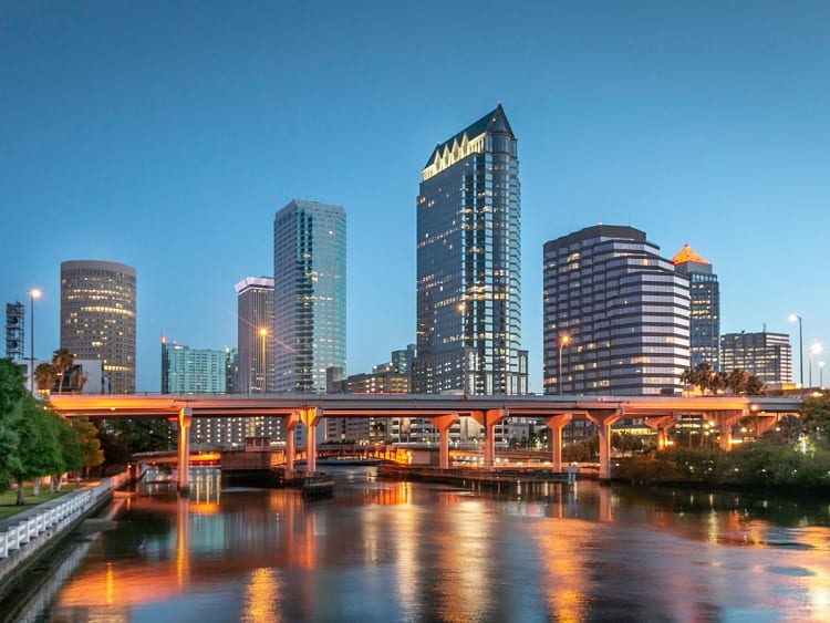 Tampa, USA &ndash; Skyline am Wasser mit beleuchteter Br&uuml;cke in der D&auml;mmerung