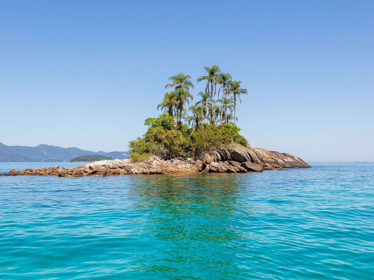 Angra dos Reis, Brasilien &ndash; Tropische Mini-Insel mit Palmen im Atlantik vor Bergkulisse