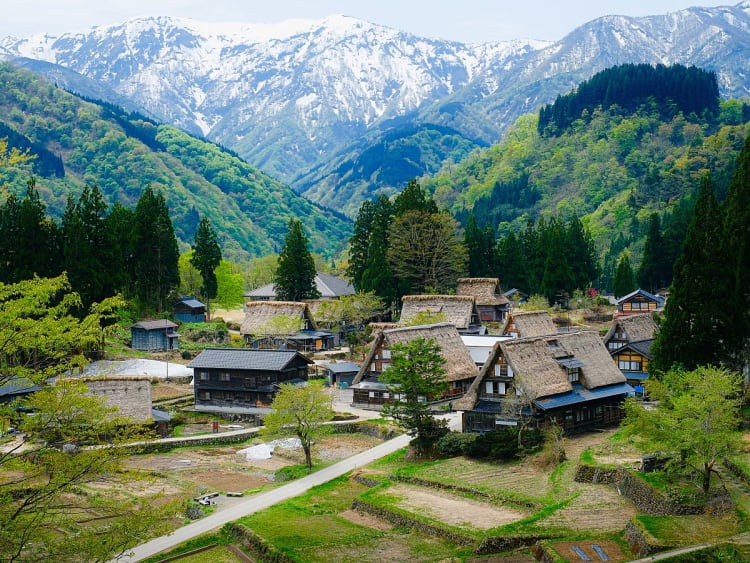 Toyama, Japan &ndash; Traditional mountain village beneath snow-capped peaks