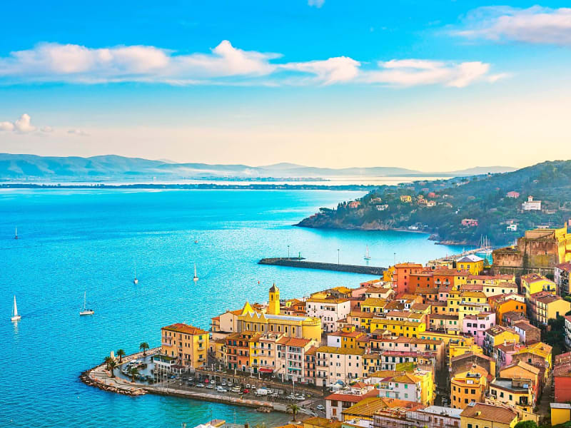 Porto Santo Stefano, Italien &ndash; Blick auf Altstadt am Meer mit Hafenmole und Segelbooten