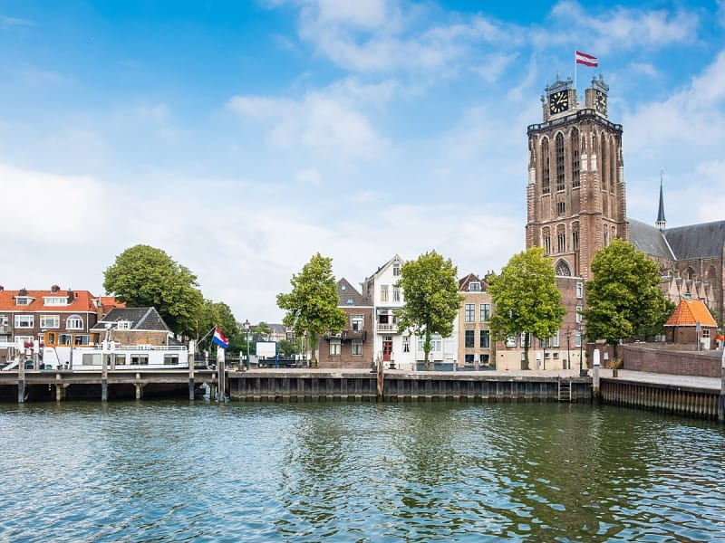 Dordrecht, Niederlande - Grote Kerk mit Uhrturm am Flussufer