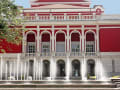 Rousse, Bulgarien – Rotes Opernhaus mit weißen Säulen und Wasserfontänen