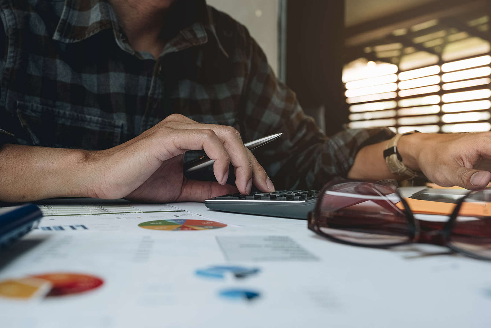 What are company shares and what is share value - Crunch - imagge of man working something out on a calculator