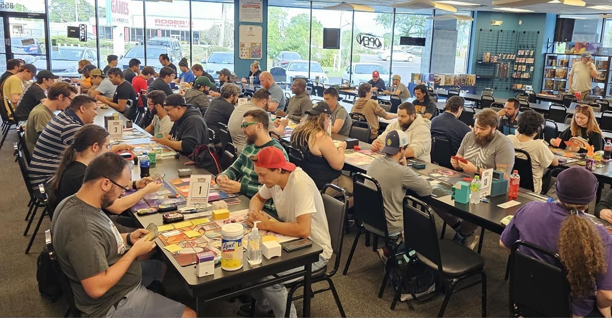 A large group of people playing Magic in a Cool Stuff Games store.