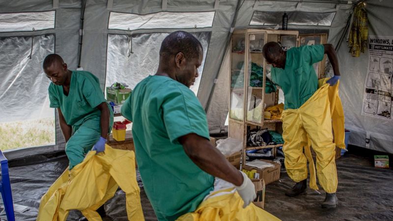 A team of medical workers don protective equipment before entering an Ebola Treatment Center in Beni, the epicenter of the outbreak in the Democratic Republic of the Congo.