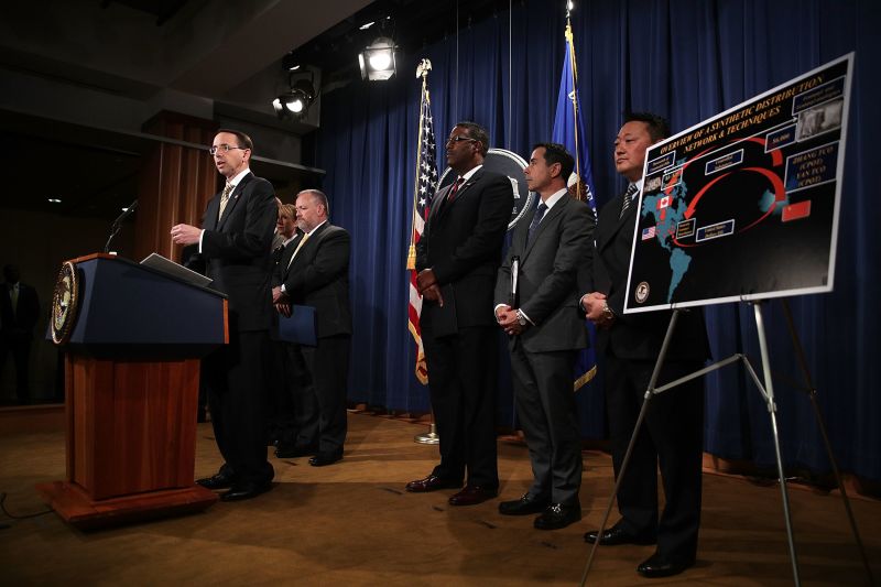 Deputy U.S. Attorney General Rod Rosenstein (L) speaks during a news conference October 17, 2017 at the Justice Department in Washington, DC. Rosenstein held a news conference to announce that federal grand juries in the Southern District of Mississippi and the District of North Dakota have indicted two Chinese nationals and their North American based traffickers and distributors for separate conspiracies to distribute large quantities of fentanyl and fentanyl analogues and other opiate substances in the U.S.