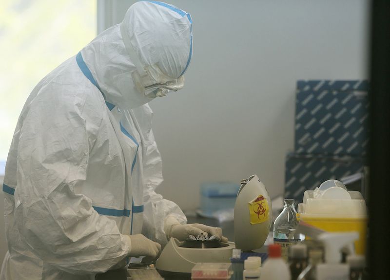 This photo taken on April 16, 2013 shows a doctor at the Beijing Center of Disease Control, working in their laboratory in Beijing.