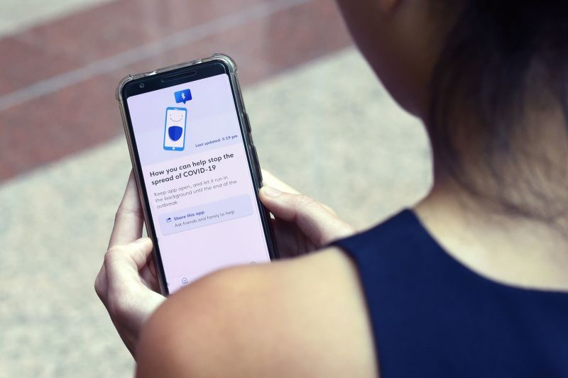 A Government Technology Agency (GovTech) staff demonstrates Singapore's new contact-tracing smarthphone app called TraceTogether, as a preventive measure against the COVID-19 coronavirus in Singapore on March 20, 2020.