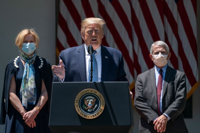 Flanked by White House coronavirus response coordinator Dr. Deborah Birx (L) and Dr. Anthony Fauci (R), director of the National Institute of Allergy and Infectious Diseases, U.S. President Donald Trump delivers remarks about coronavirus vaccine development in the Rose Garden of the White House on May 15, 2020 in Washington, DC. 