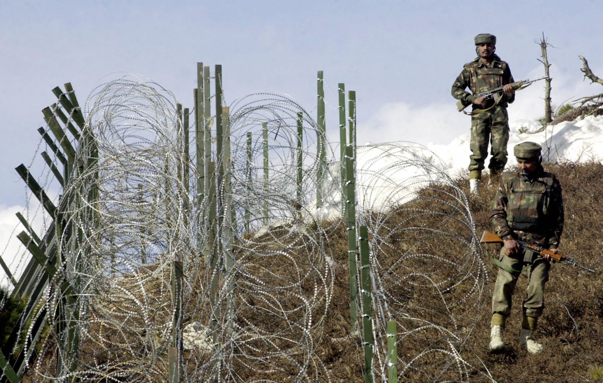 Indian soldiers patrol along a barbed-wire fence, 04 December 2003, near Baras Post on the Line of Control (LoC) between Pakistan and India some 174 kilometers north west of Srinagar. (SAJJAD HUSSAIN/AFP via Getty Images) Indian soldiers patrol along a barbed-wire fence, 04 December 2003, near Baras Post on the Line of Control (LoC) between Pakistan and India some 174 kilometers north west of Srinagar. (SAJJAD HUSSAIN/AFP via Getty Images)