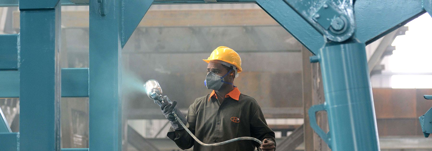 A worker spray paints a steel frame at a heavy fabrication manufacturing factory in Vasna Buzarg village. (SAM PANTHAKY/AFP/Getty Images) A worker spray paints a steel frame at a heavy fabrication manufacturing factory in Vasna Buzarg village. (SAM PANTHAKY/AFP/Getty Images)
