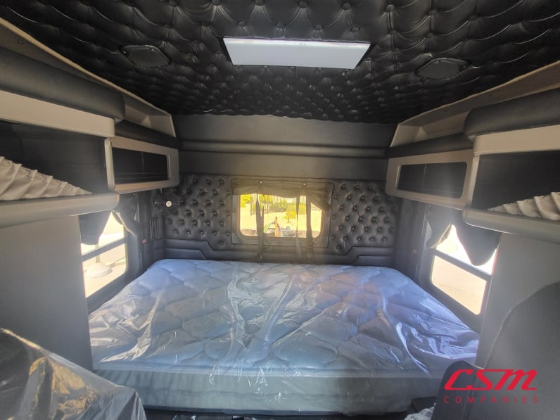 Interior wide sleeper view for this 2025 Kenworth W900L (Stock number: SR177262)
