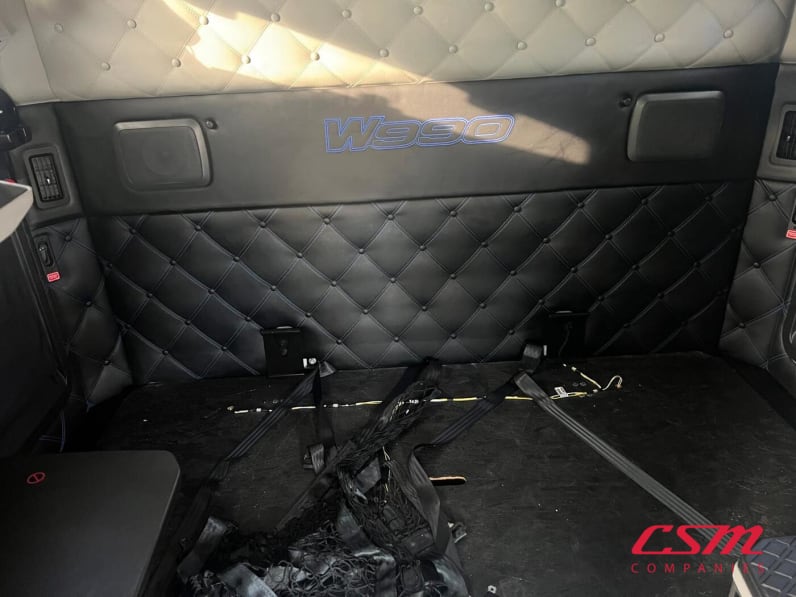 Interior wide sleeper view for this 2023 Kenworth W990 (Stock number: UPJ220957)