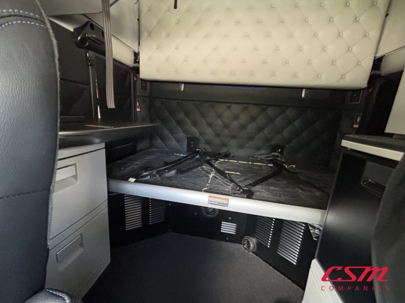 Interior wide sleeper view for this 2023 Kenworth W990 (Stock number: UPJ220959)
