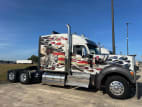 Exterior full passenger side for this 2023 Kenworth W990 (Stock number: UPJ220964)