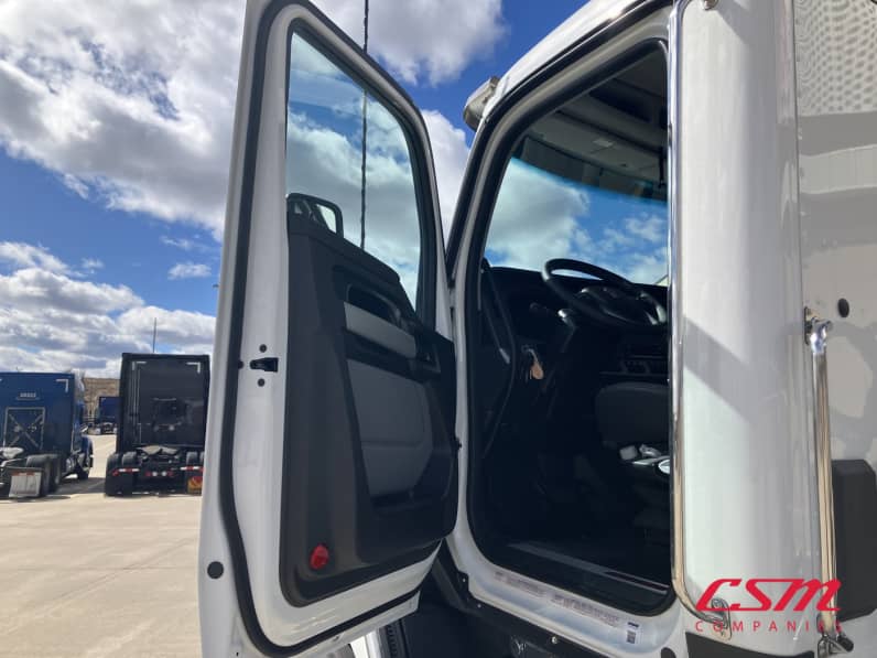Drivers side door open for this 2026 Kenworth T680 Short Hood (Stock number: TJ230322)