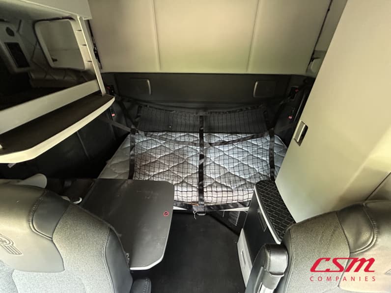 Interior wide sleeper view for this 2023 Kenworth T680 (Stock number: UPJ217559)