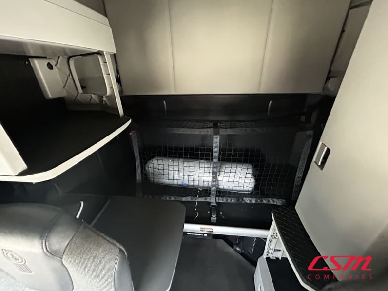 Interior wide sleeper view for this 2023 Kenworth T680 (Stock number: UPJ217006)