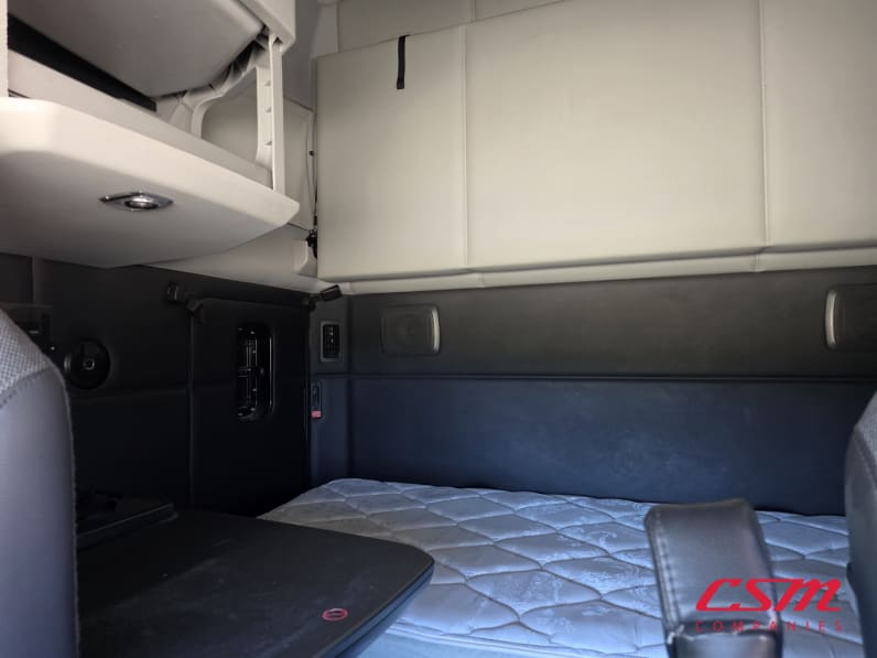 Interior wide sleeper view for this 2023 Kenworth T680 (Stock number: UPJ216963)