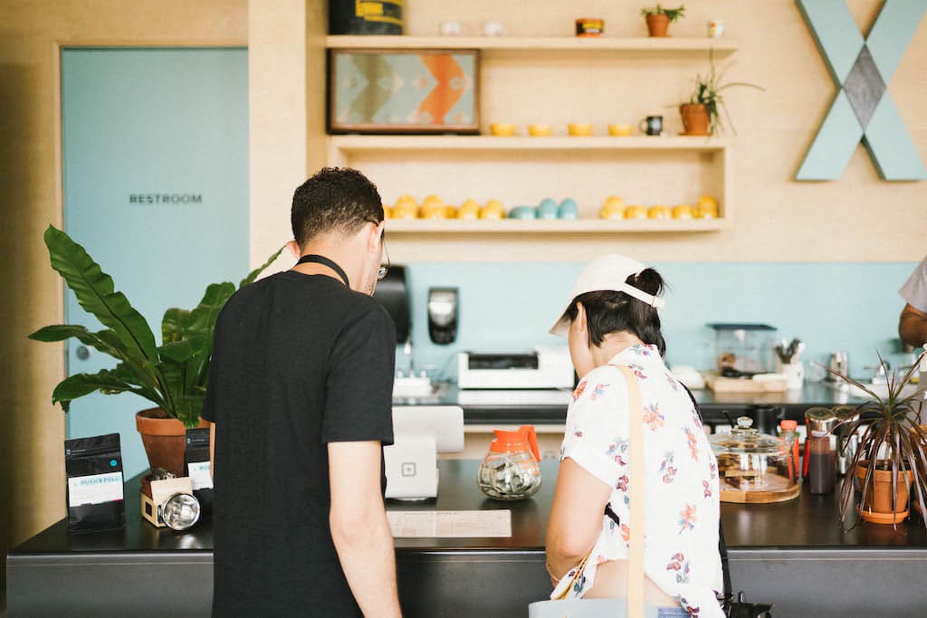 Jordan and Sarah looking at the menu in a coffee shop